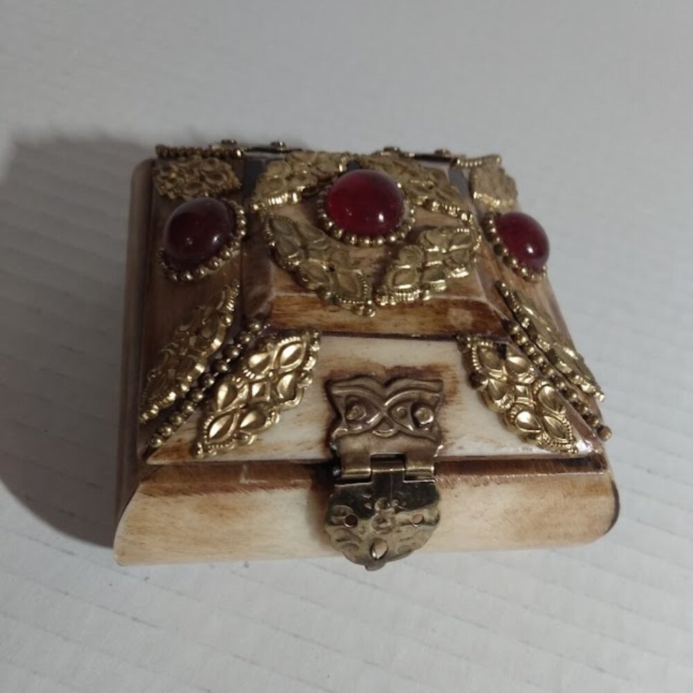 Small trinket storage organizer with gold tone metal design & red faux jewels.